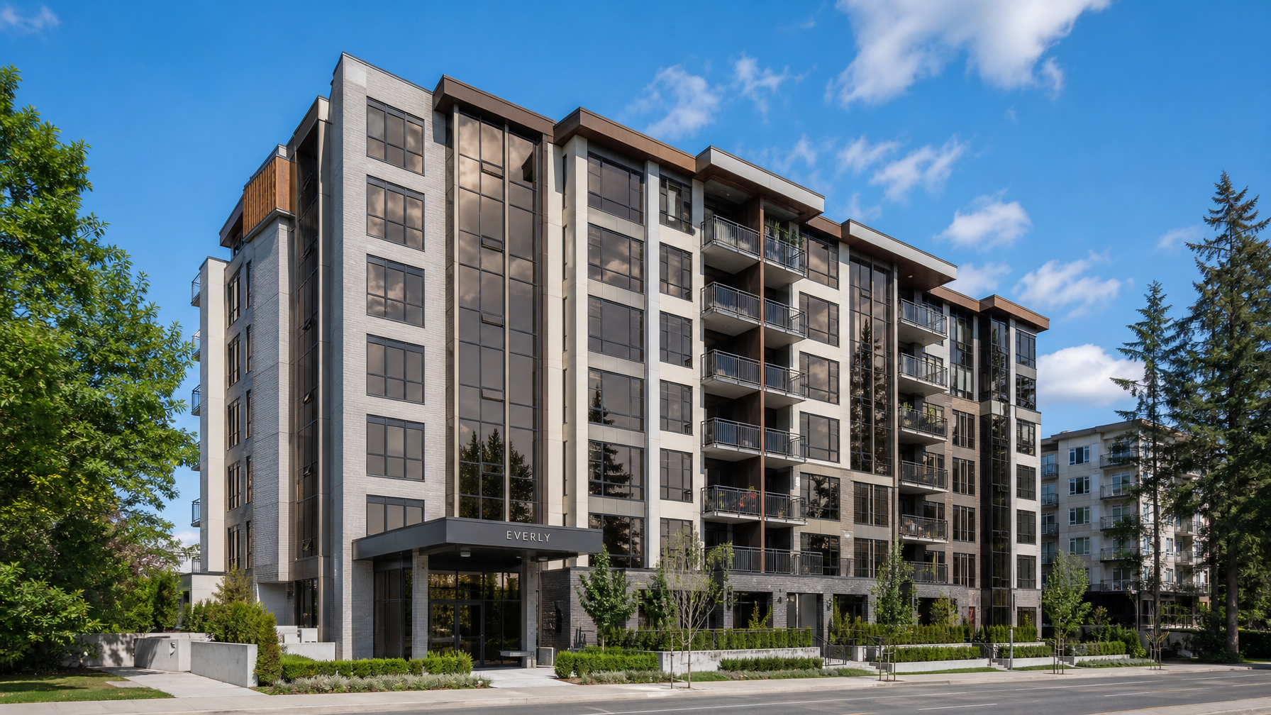 Modern Surrey, BC mid-rise strata condo building with professionally installed window tinting film, subtle reflective bronze-grey glass exterior