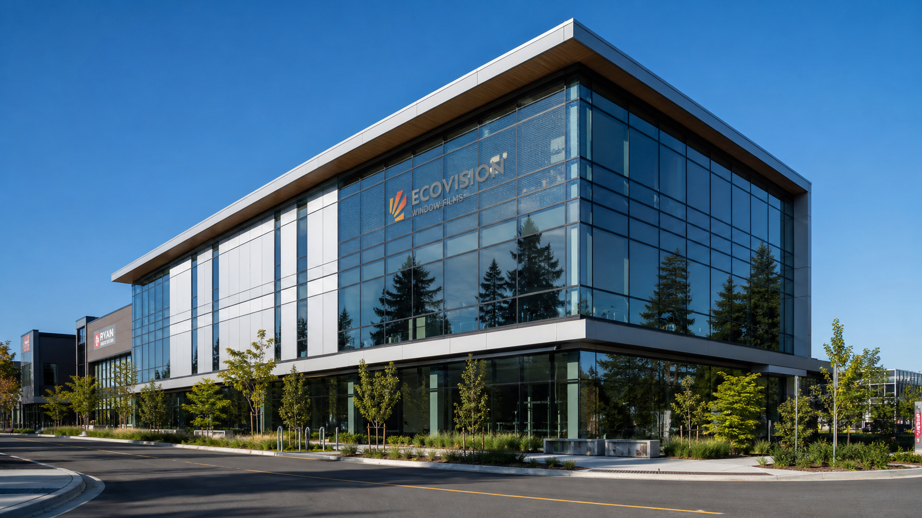 Modern British Columbia commercial office building with bird-safe window film dot patterns visible on glass facade
