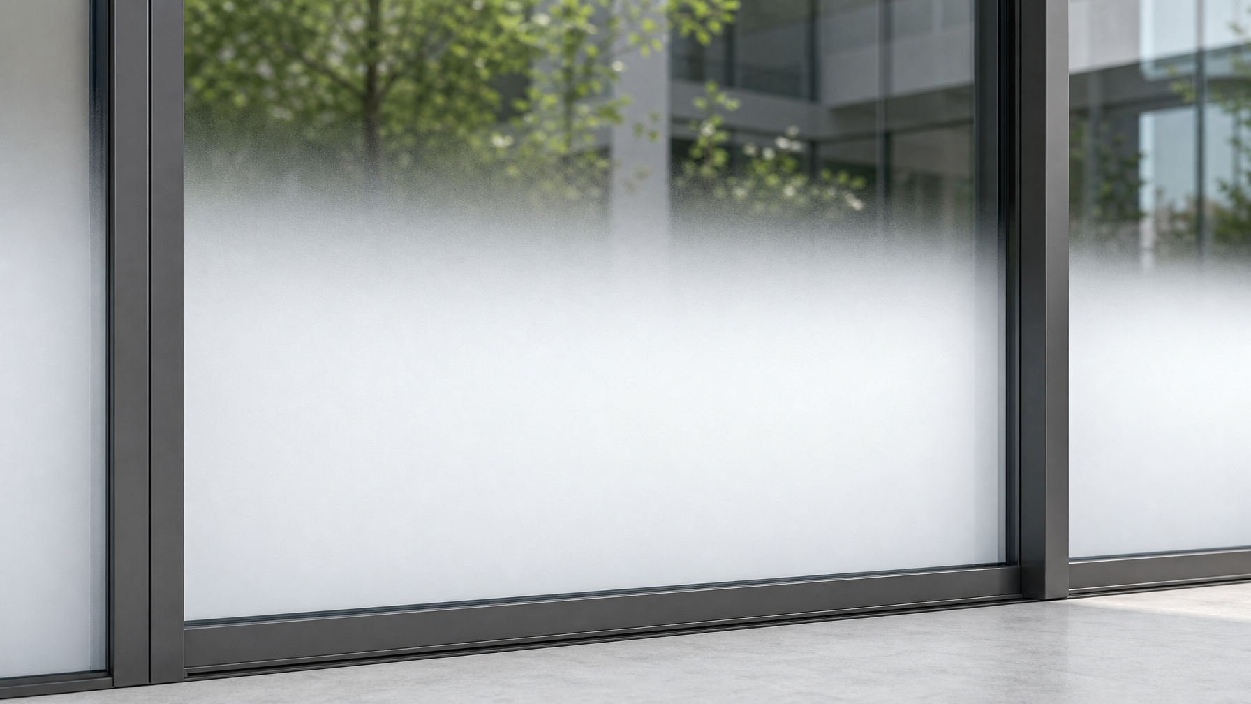 Close-up of gradient window film showing smooth fade from frosted white at the bottom to fully clear glass at the top