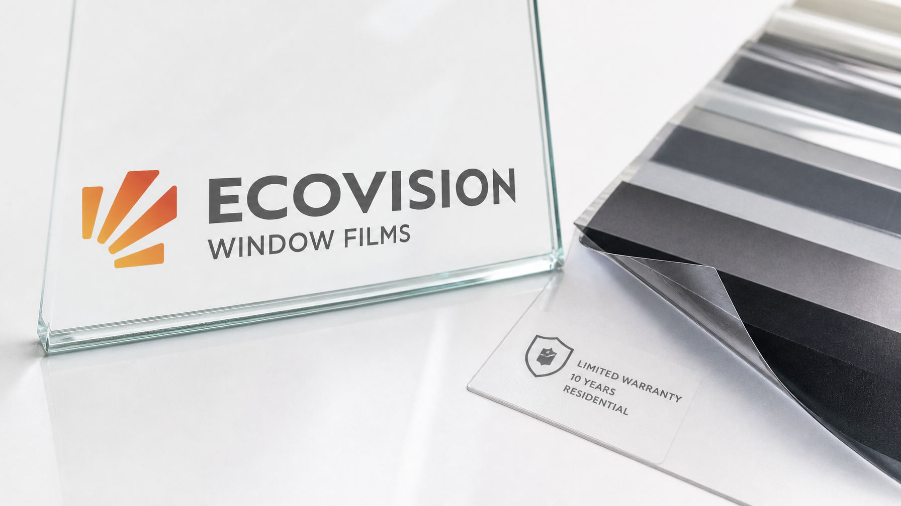 Close-up of architectural window film samples and warranty label area on glass