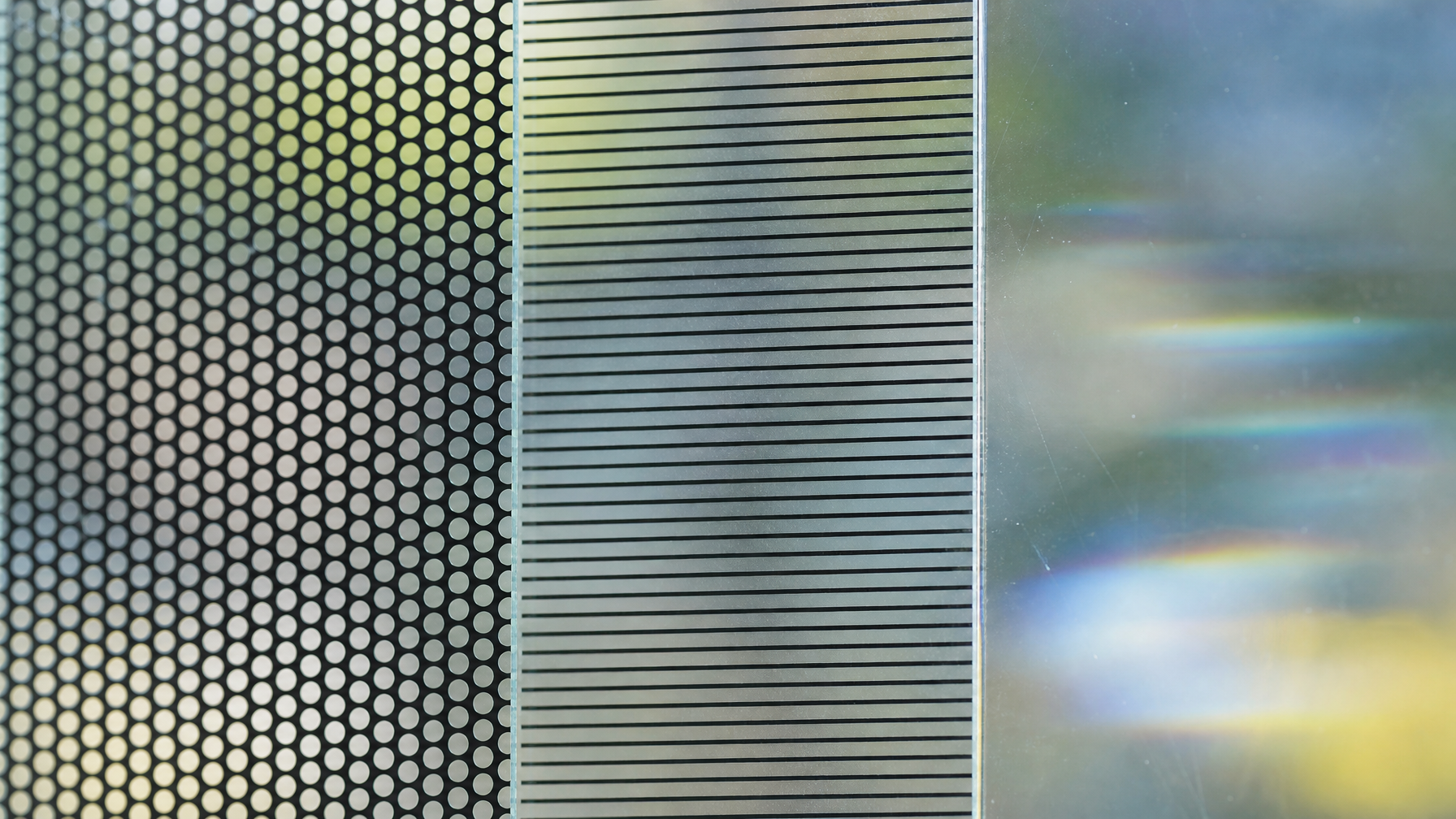 Close-up macro detail of bird-safe window film showing dot fritting, horizontal line, and UV-reflective pattern zones