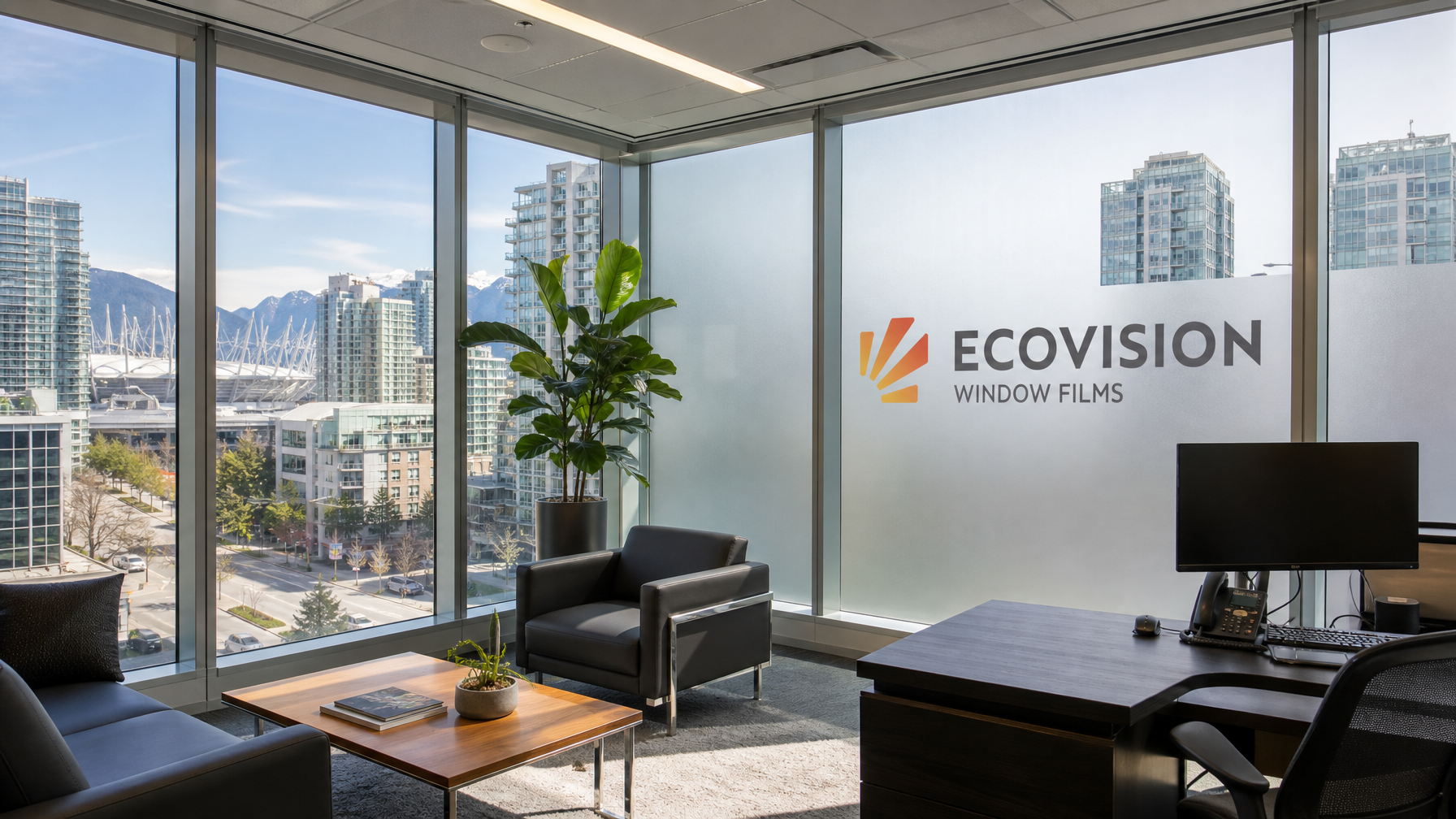 Modern Vancouver commercial office interior with solar window film and vinyl company logo graphics applied over the filmed glass panels
