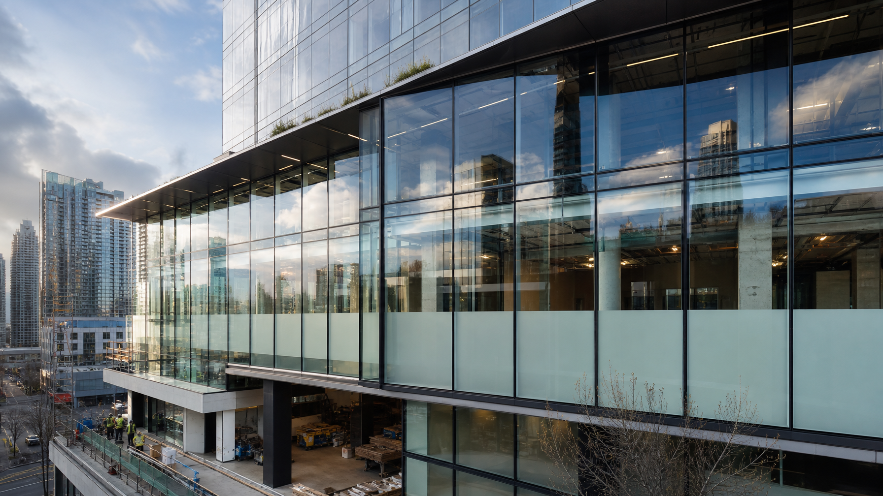 Vancouver commercial building glass with opaque privacy film sections during construction fit-out