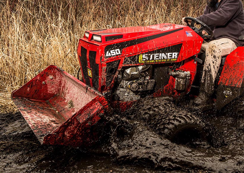Steiner tractor working in the mud.