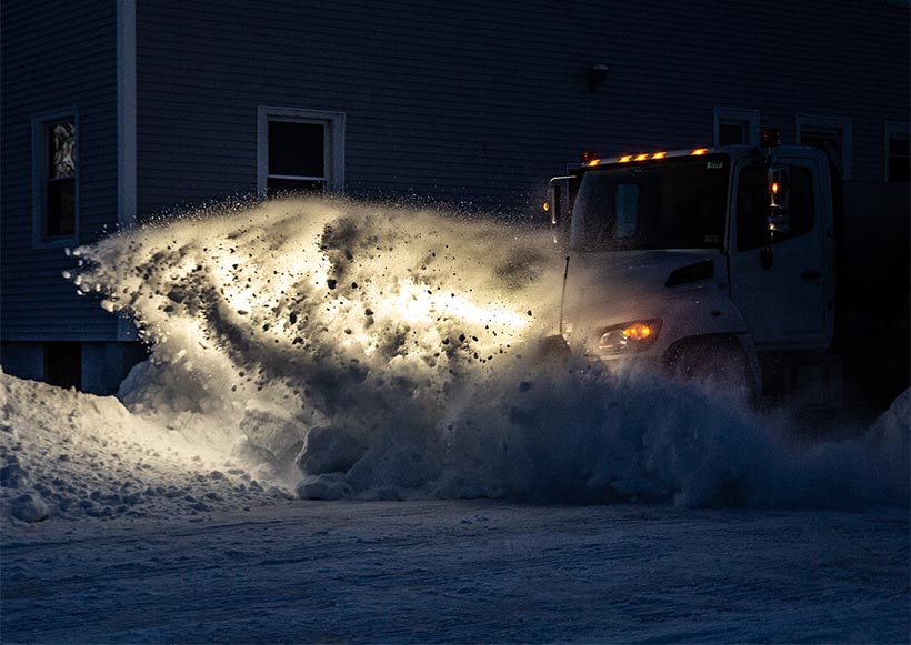 Snowplow in action at night.