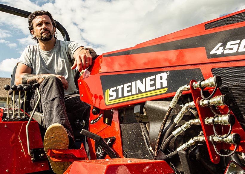 Man operating a Steiner tractor.