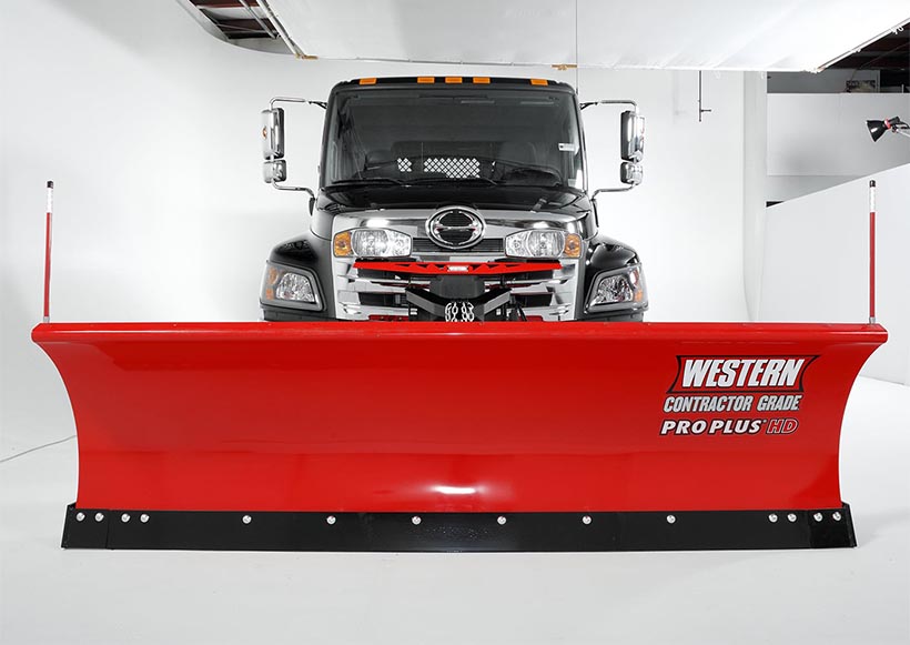 Western snow plow on a semi truck in a photo studio.