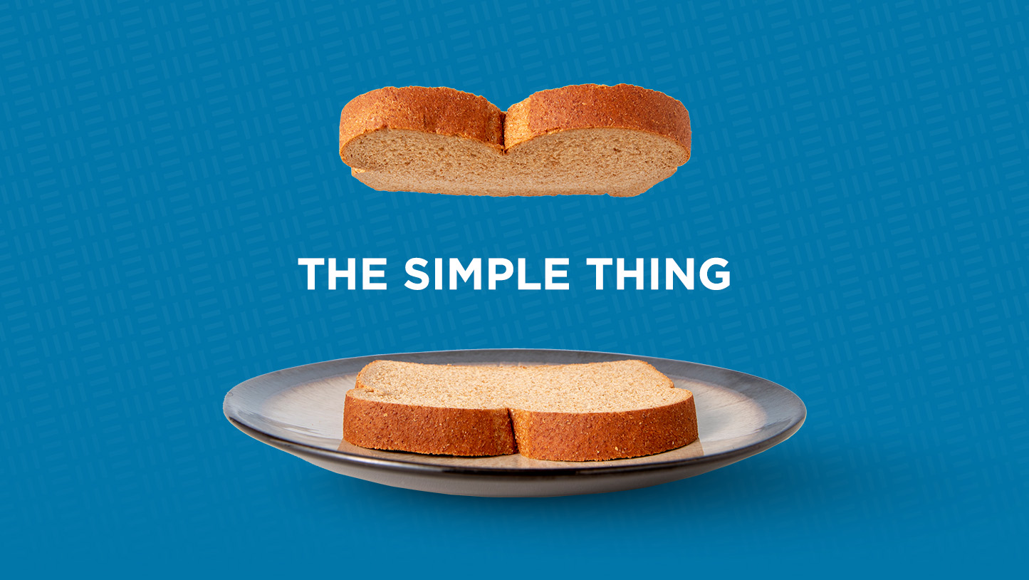 Image of two pieces of bread on a plate with the copy "The simple thing" between them.
