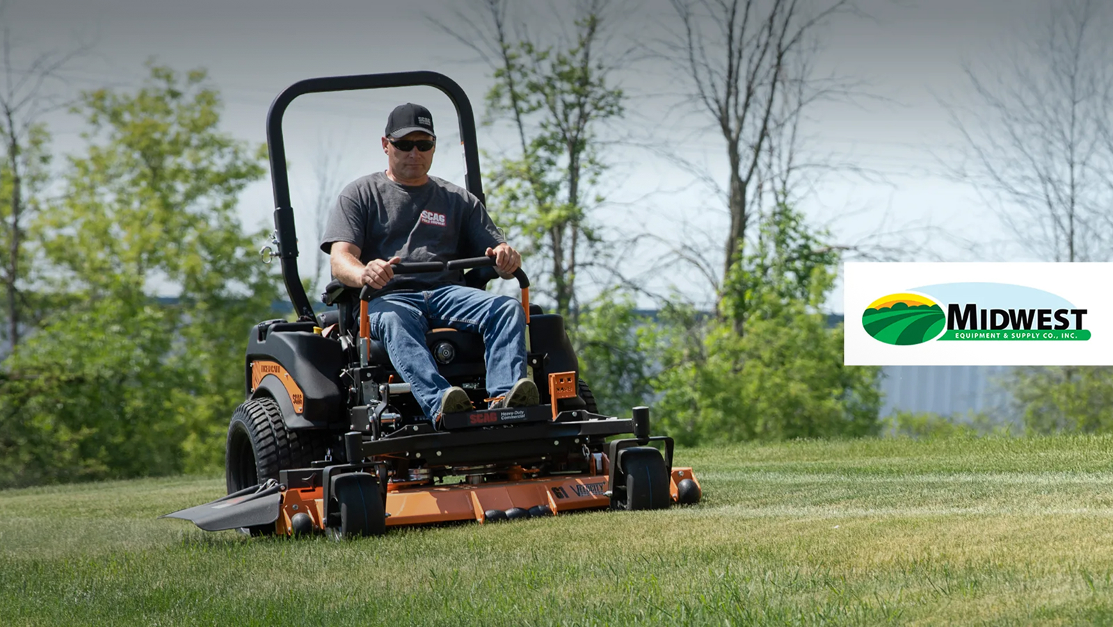 Man wearing a cap and sunglasses operating a zero-turn lawn mower on a grassy field with trees in the background; logo on the right reads “Midwest Equipment & Supply Co., Inc.”