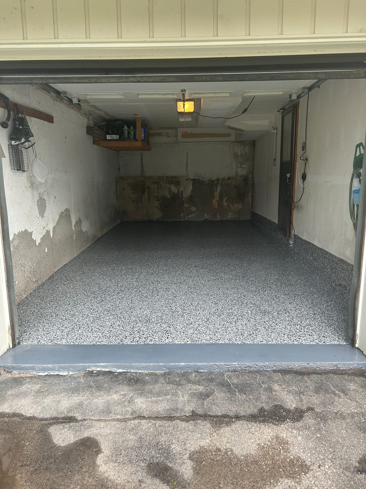 Wide view of finished epoxy garage floor from doorway