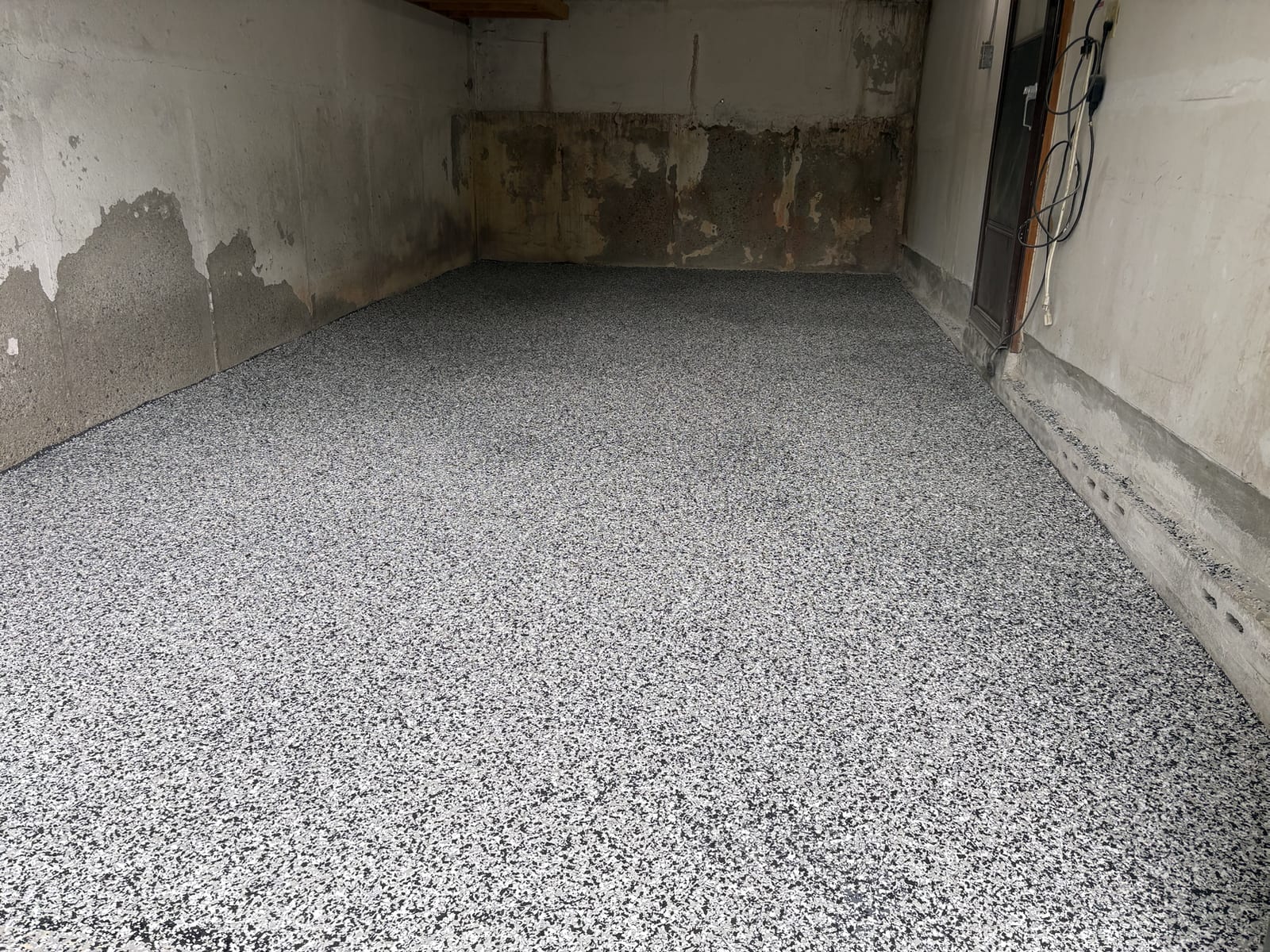 Fresh speckled epoxy coating on garage floor
