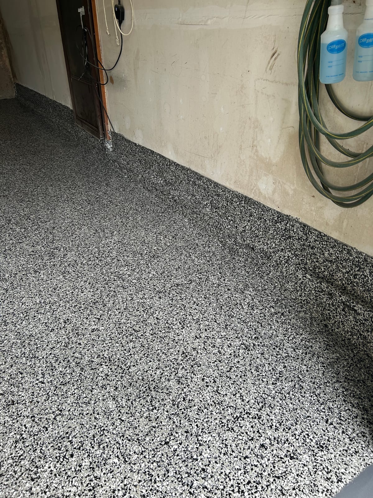 Close-up of grey and white flake epoxy floor