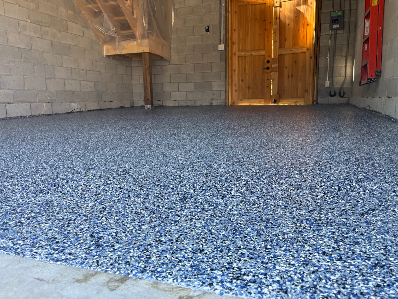 Wide view of finished blue speckled epoxy garage floor