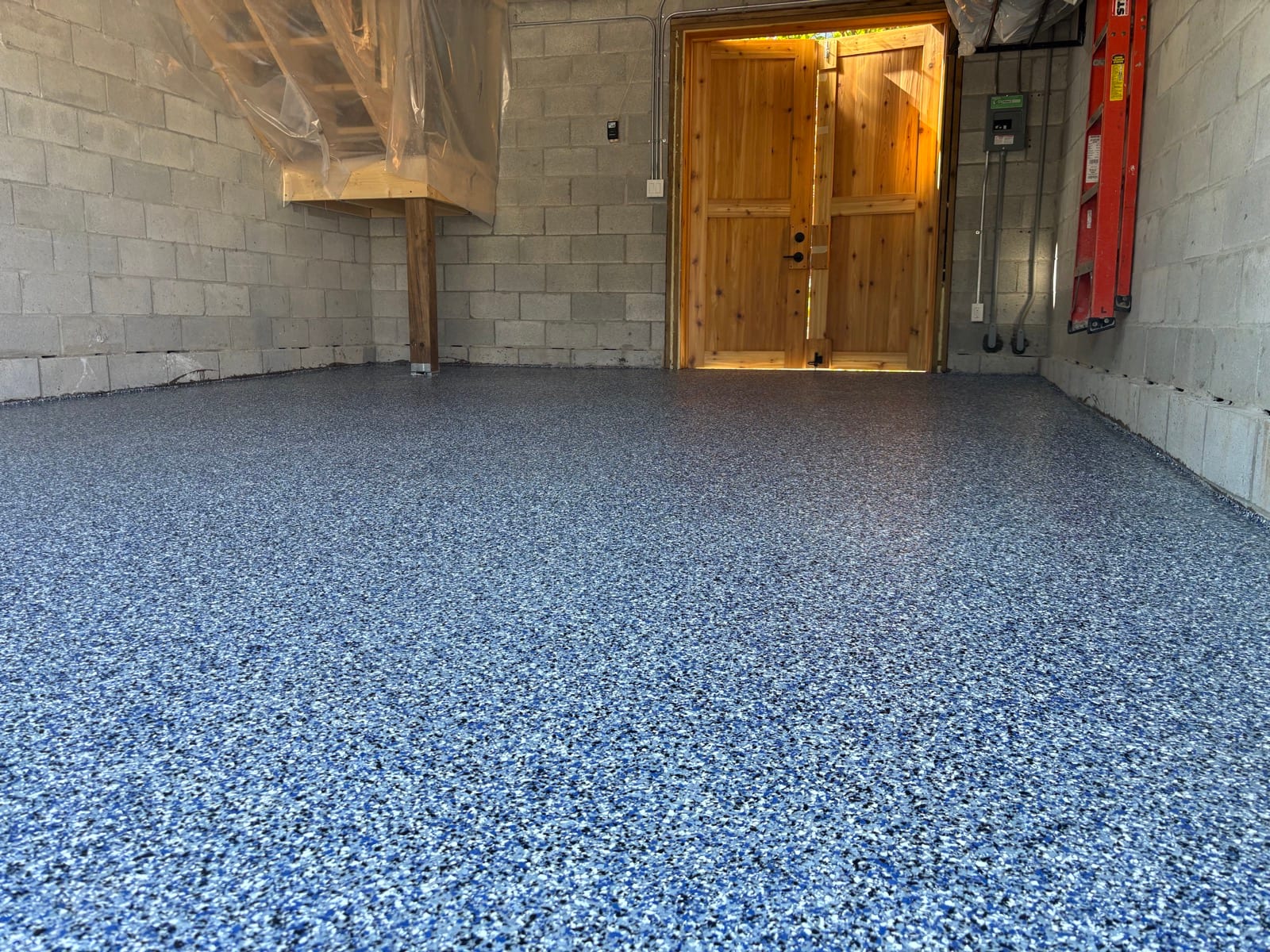 Finished blue flake epoxy floor in empty garage