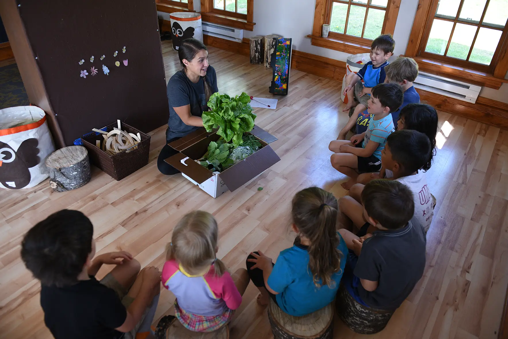 Worker leads children through lesson.