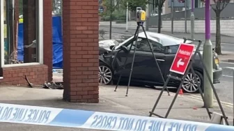 Man in his 20s killed as car crashes through estate agents