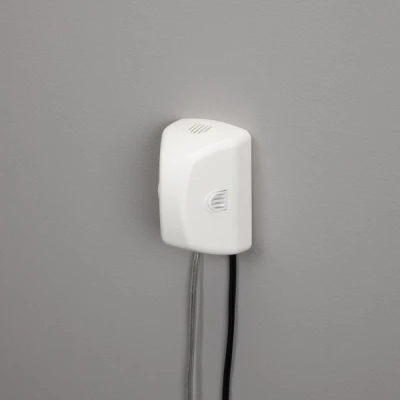 White Outlet Cover with Built-In Cord Shortener for Electrical Safety