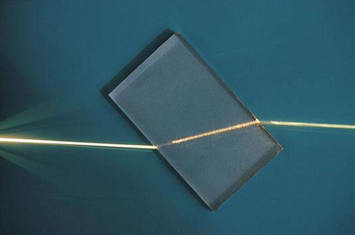 A ray of light being refracted in a plastic block.