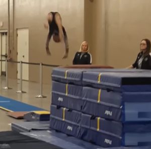 Coach-Catches-Gymnast