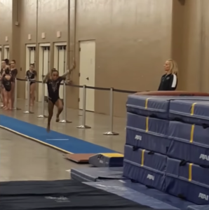 coach-catches-gymnast