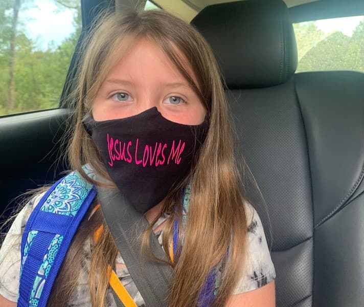 school girl banned for wearing Jesus loves me mask