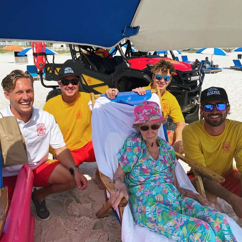 lifeguards carry elderly woman to beach-3