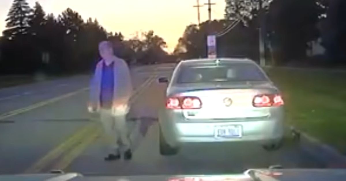 police officer helping elderly man set up tv