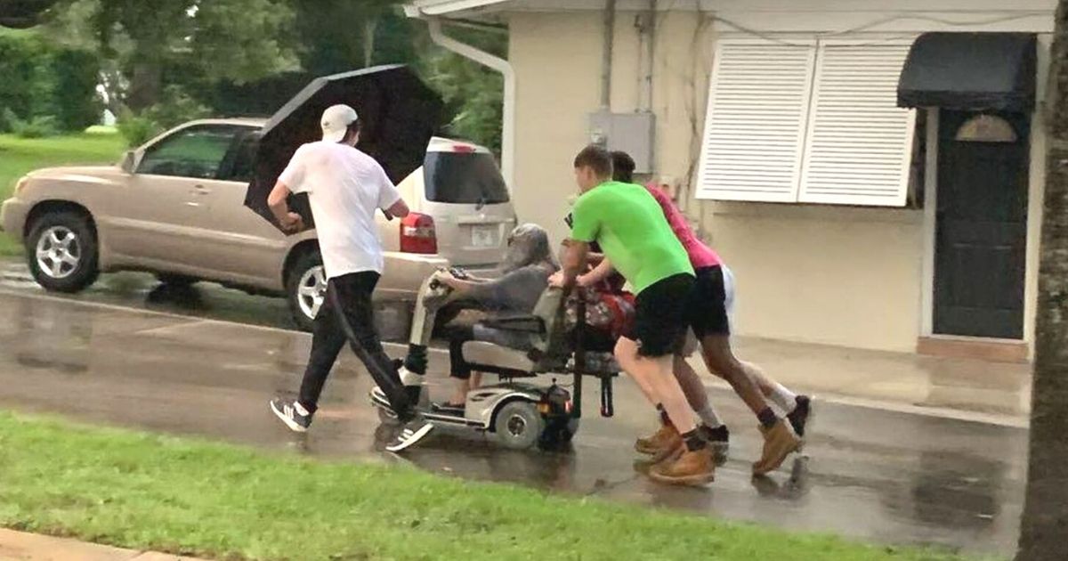 men push elderly woman