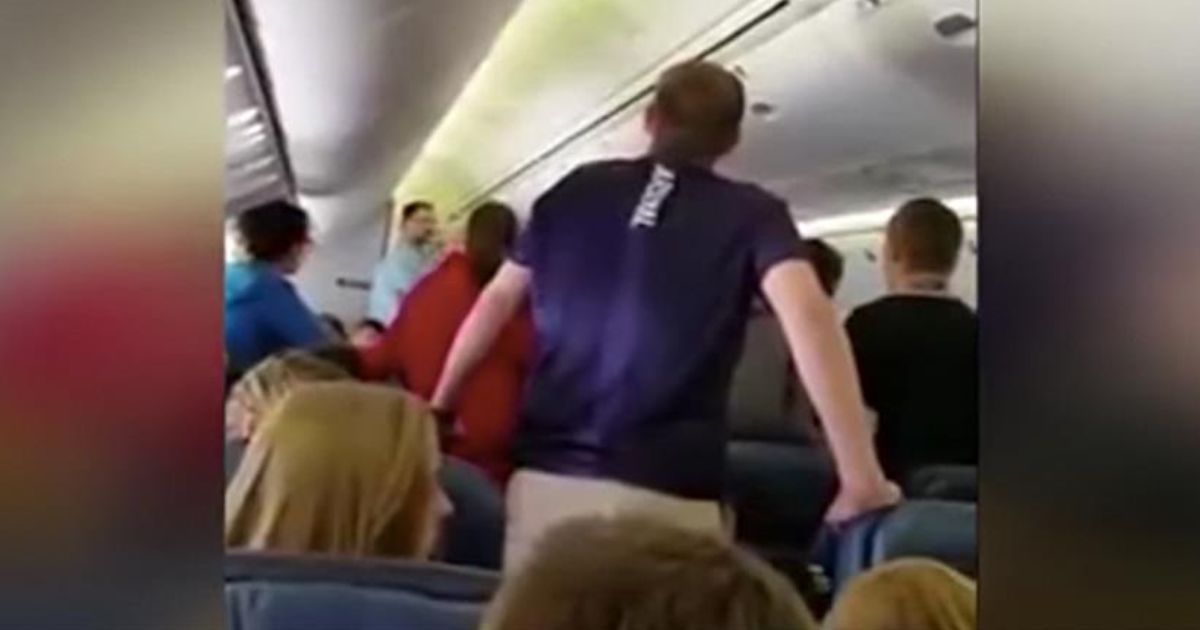 choir on plane sings for fallen soldier