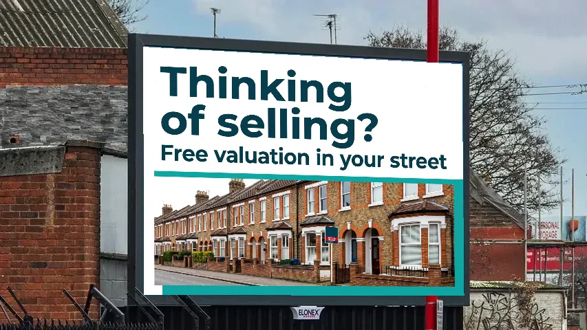 Example estate agent billboard ad reading Thinking of selling? Free valuation in your street, on a roadside digital screen on Tyburn Road, Birmingham