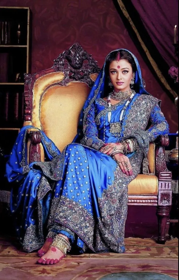 Aishwarya Rai Bachchan as Paro in Devdas, styled in opulent textiles and intricate jewellery, embodies the cinematic peak of Indian maximalism.