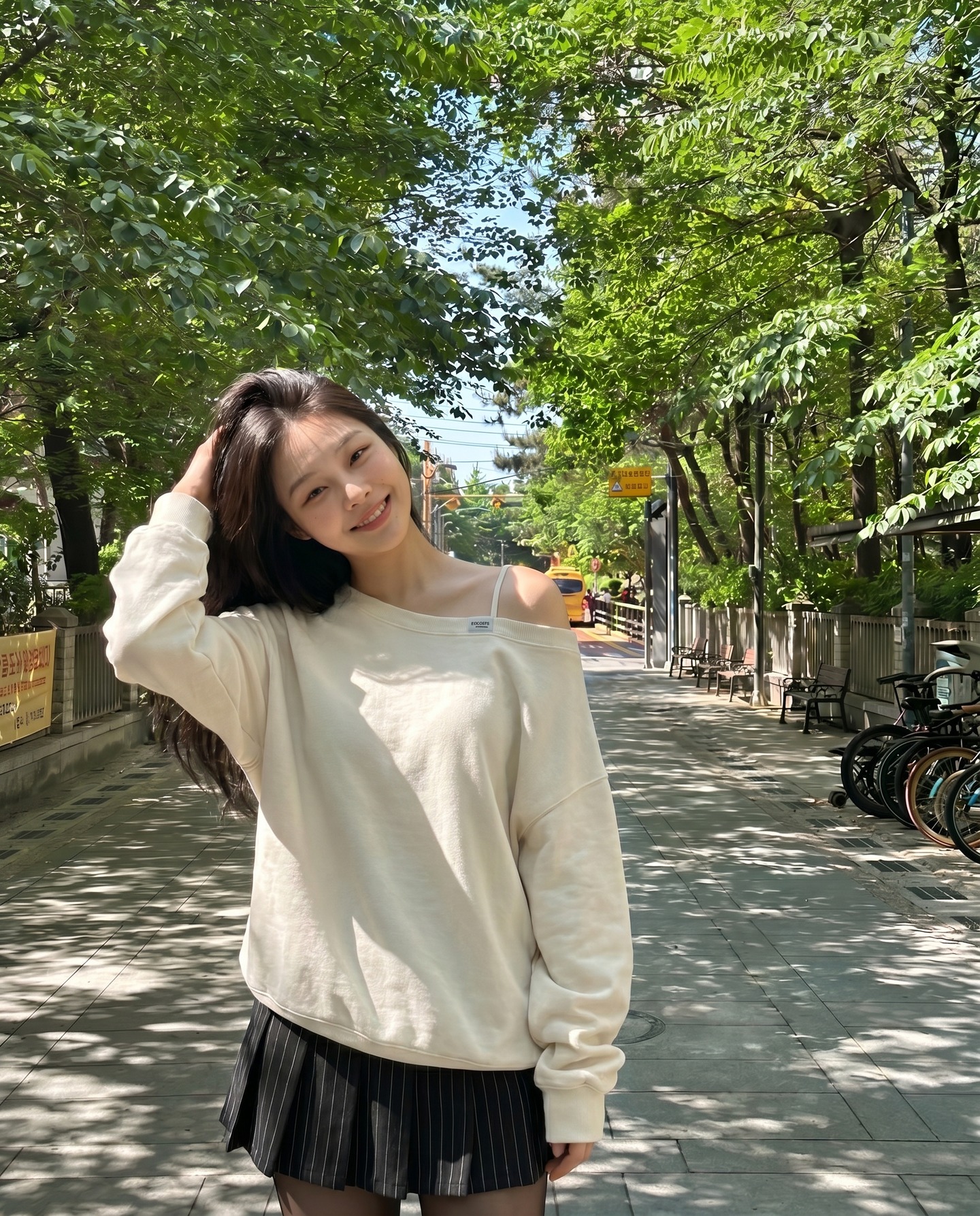 Korean model on tree-lined street in Seoul, hand in hair