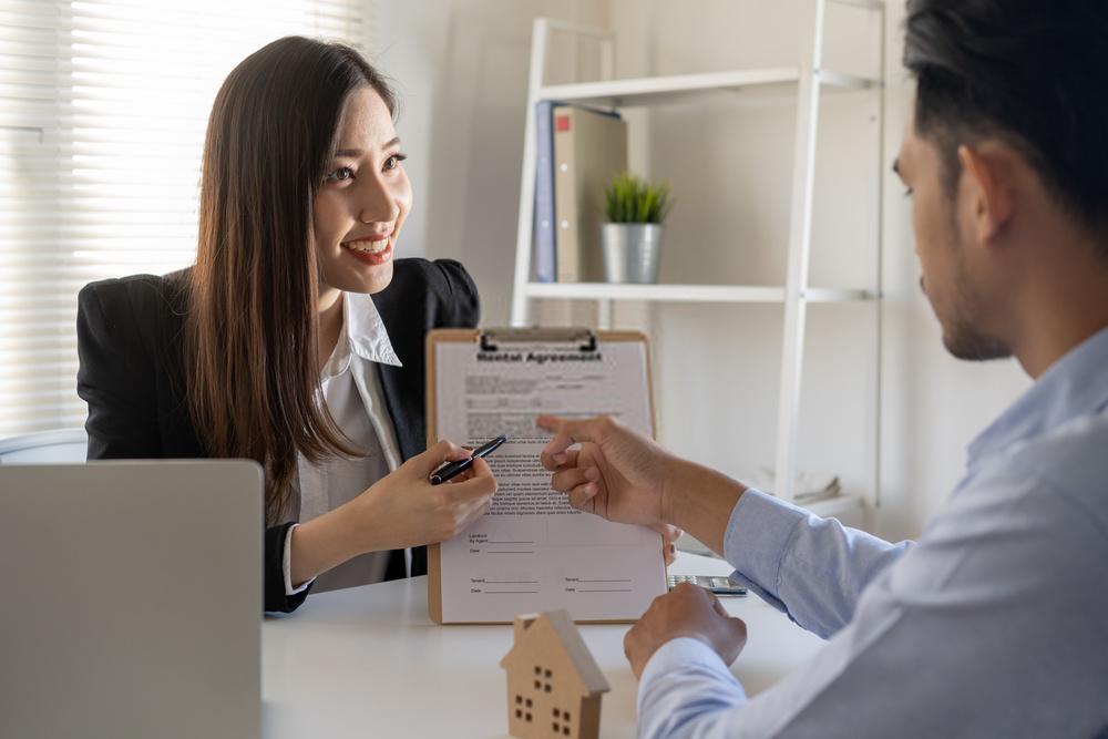 Woman reviewing paperwork with man