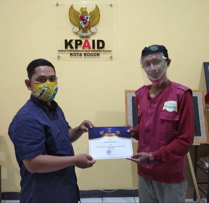 Two men discussing self development services, one with a face mask, the other with a face shield. They are smiling at each other and looking at a certificate, suggesting a successful achievement in the realm of self improvement. This is an example of the kind of work done by our freelance services.