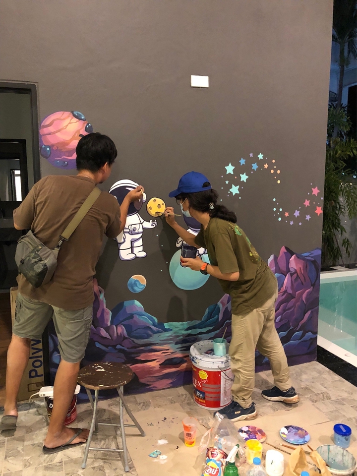 รับวาดภาพประกอบงานอีเว้นท์ ศิลปินวาดภาพสองคน กำลังวาดภาพประกอบงานอีเว้นท์ บนผนัง