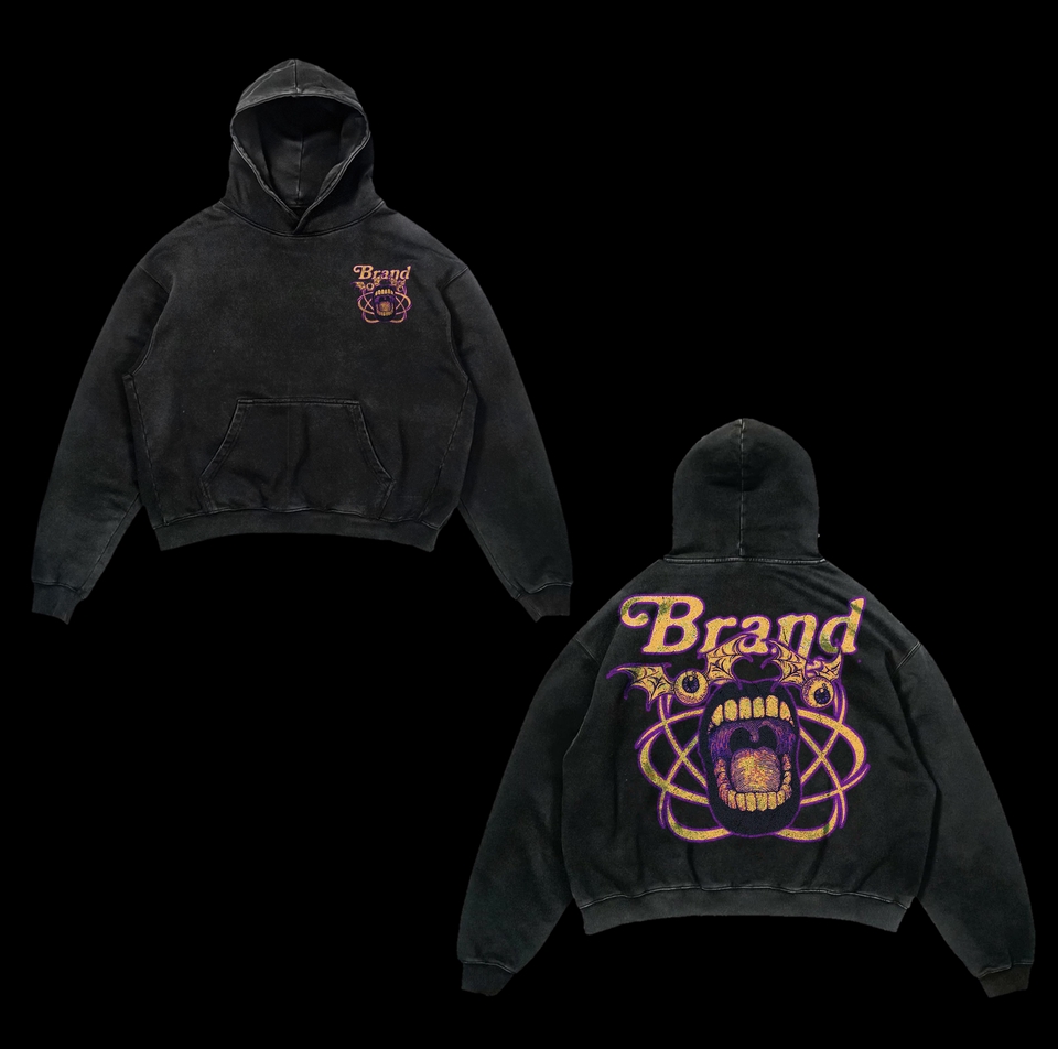 Desain hoodie polos hitam dengan desain custom logo "Brand" berwarna emas dan ungu.