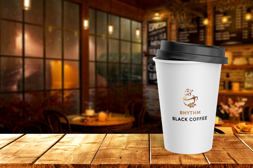 Desain kemasan kotak minuman hitam dengan label "Rhythm Black Coffee" yang unik dan menarik.
