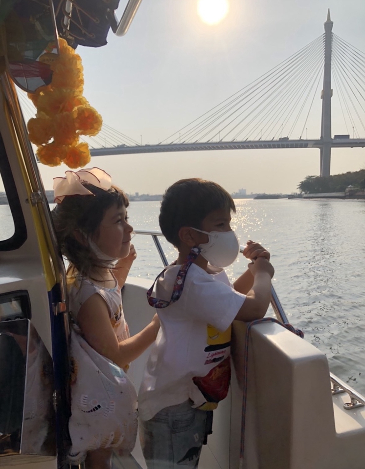 เด็กๆ สวมหน้ากากอนามัยกำลังเดินทางโดยเรือ บริการไกด์ส่วนตัว เที่ยวกรุงเทพ ไกด์พาเที่ยวกรุงเทพ