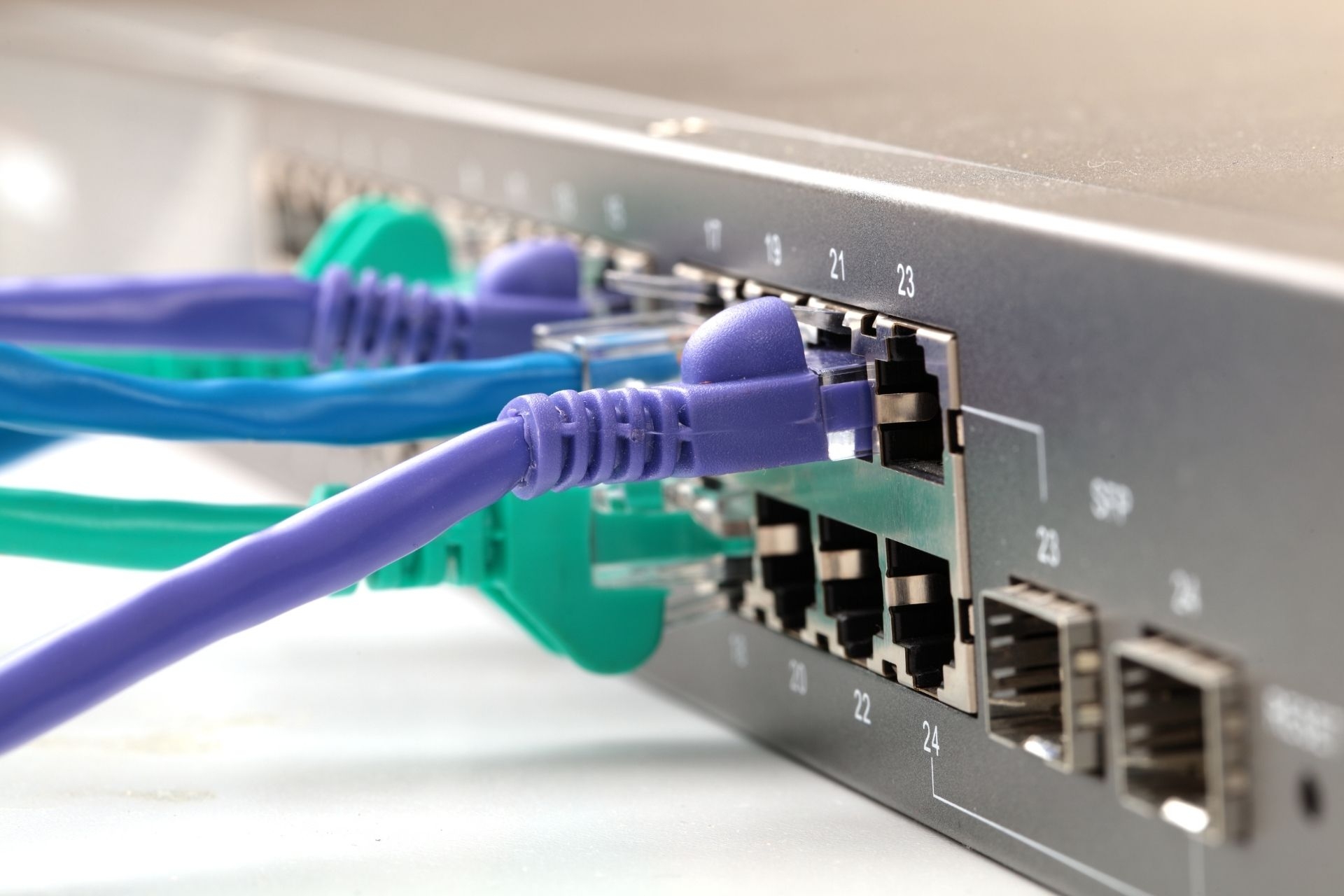 What is the purpose of using a fiber optic patch panel in a network setup?