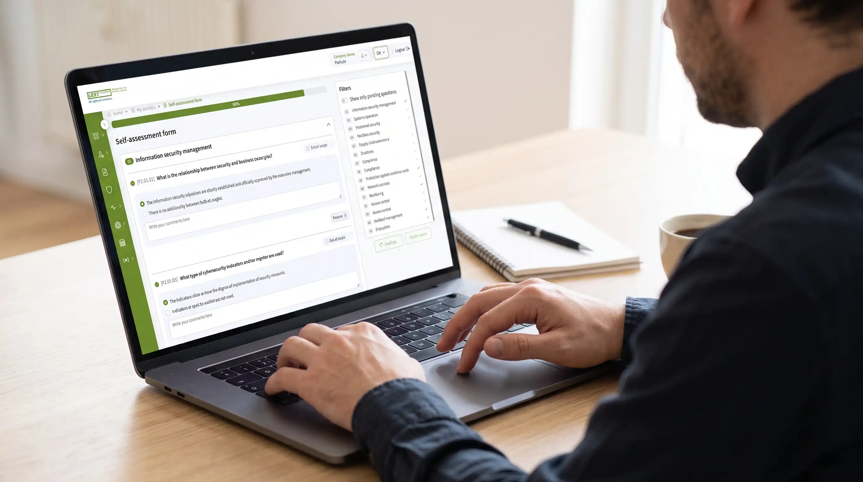 Person completing the LEET Self-assessment form on a laptop, with the 14 cybersecurity domains listed alongside the questionnaire