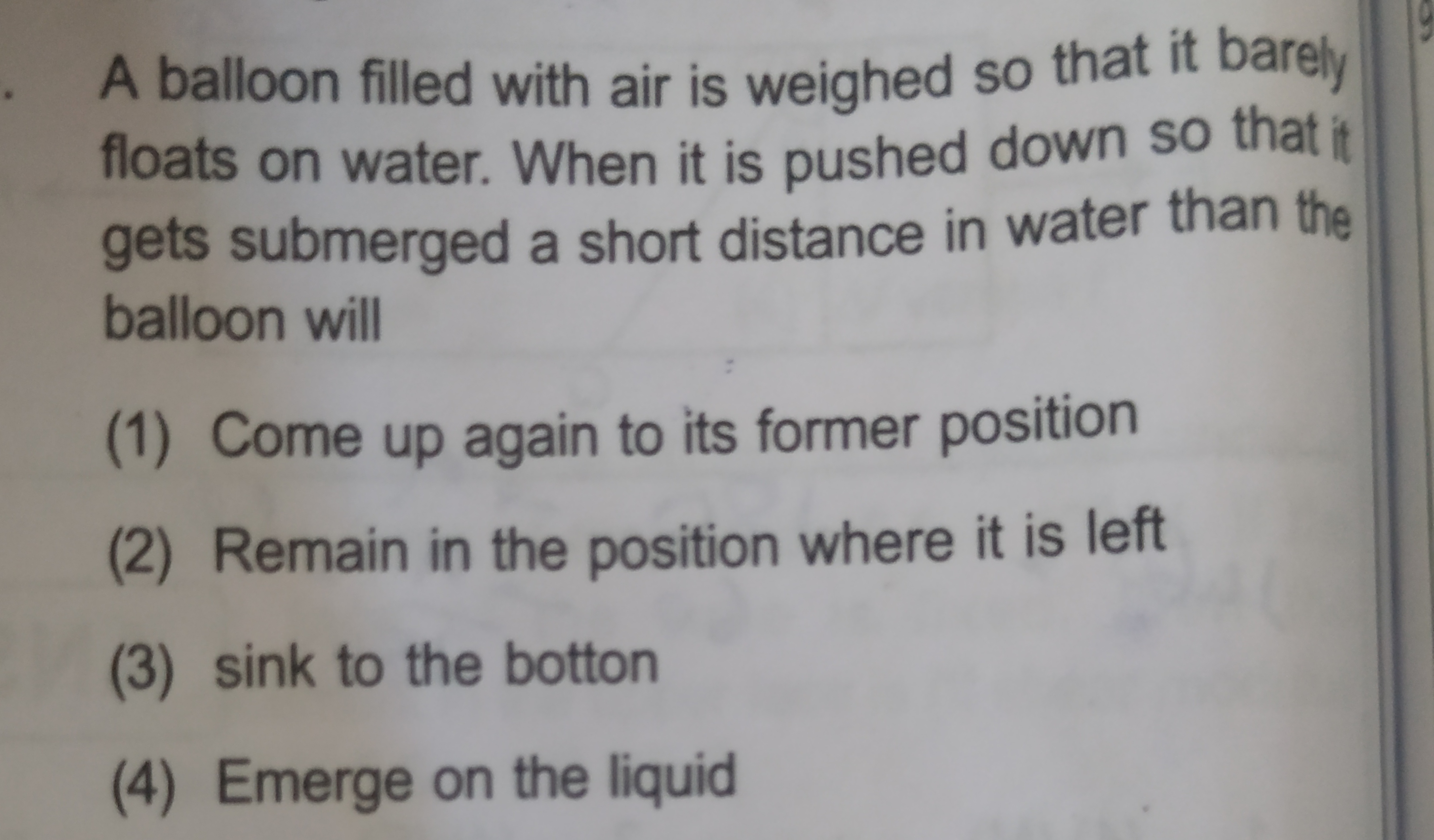 A balloon filled with air is weighed so that it barely floats on water