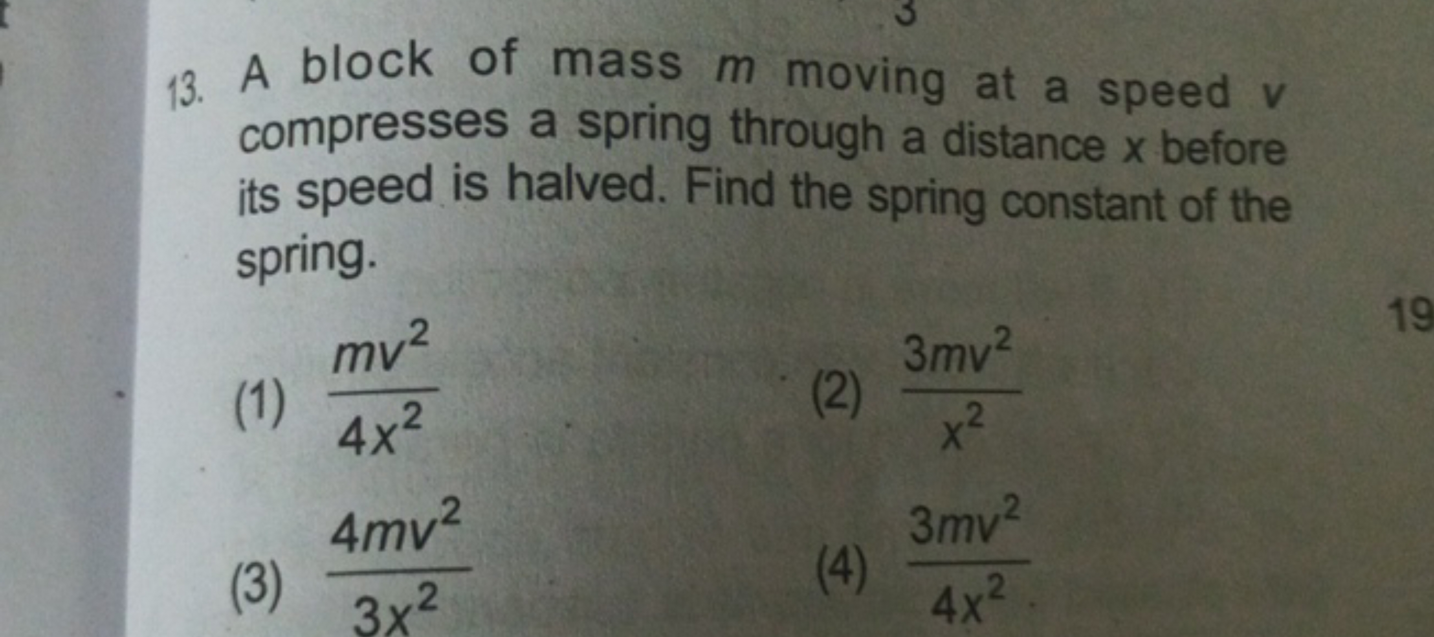 13. A block of mass m moving at a speed v compresses a spring through 