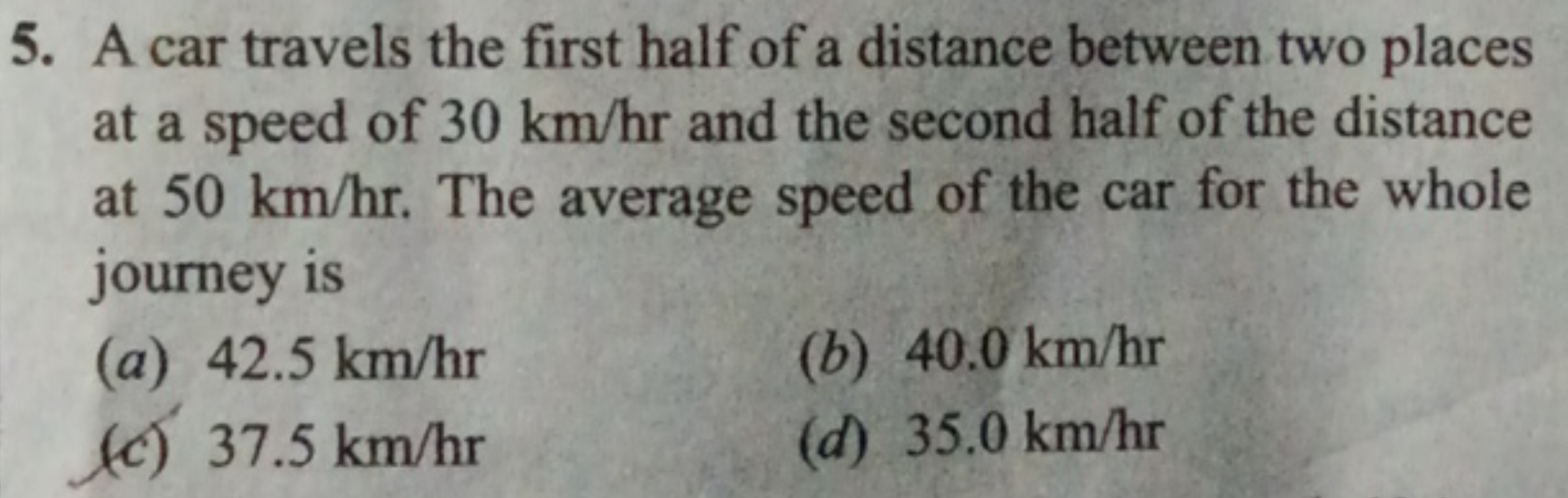 5. A car travels the first half of a distance between two places at a 