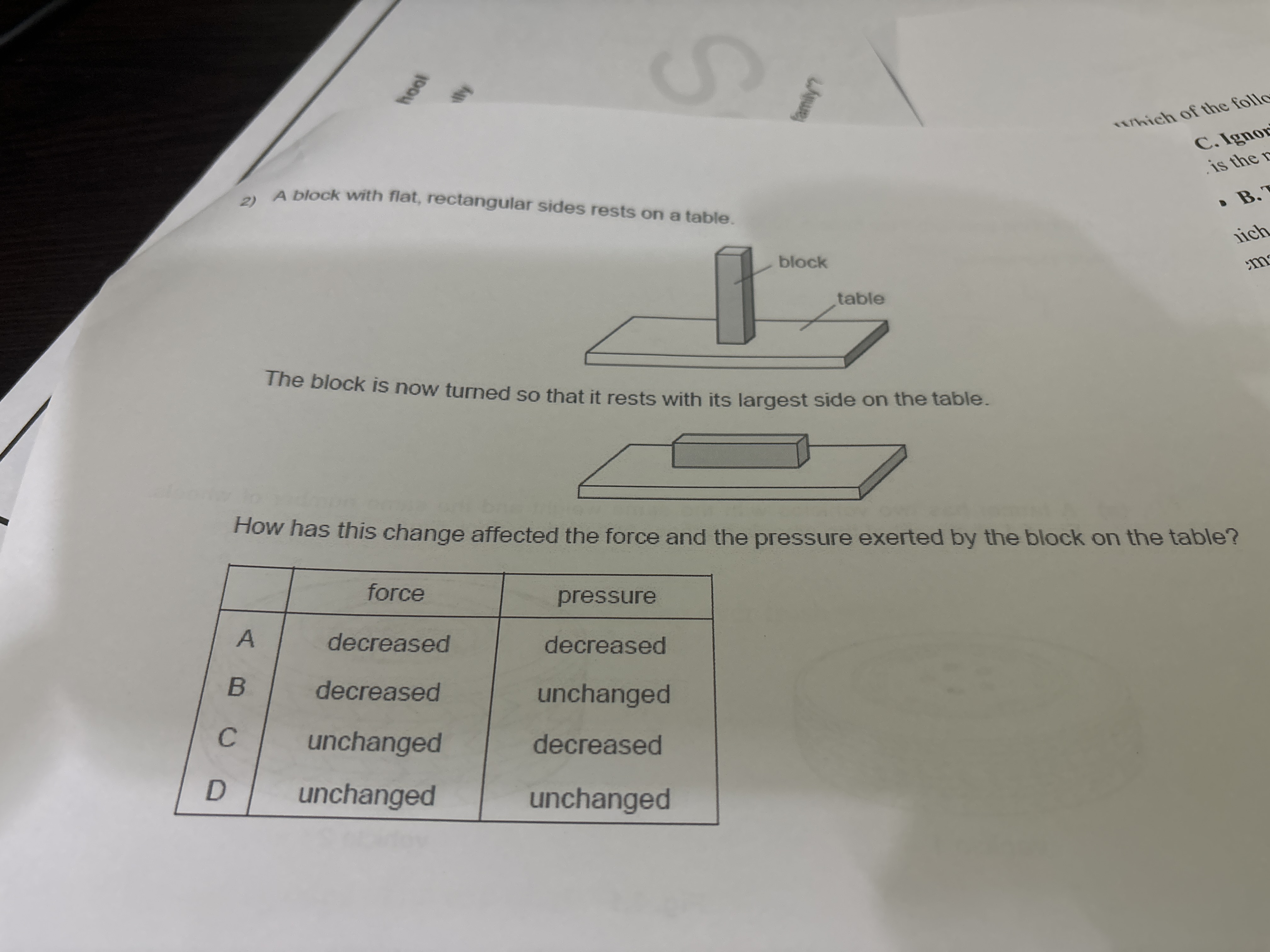 2) A block with flat, rectangular sides rests on a table.

The block i