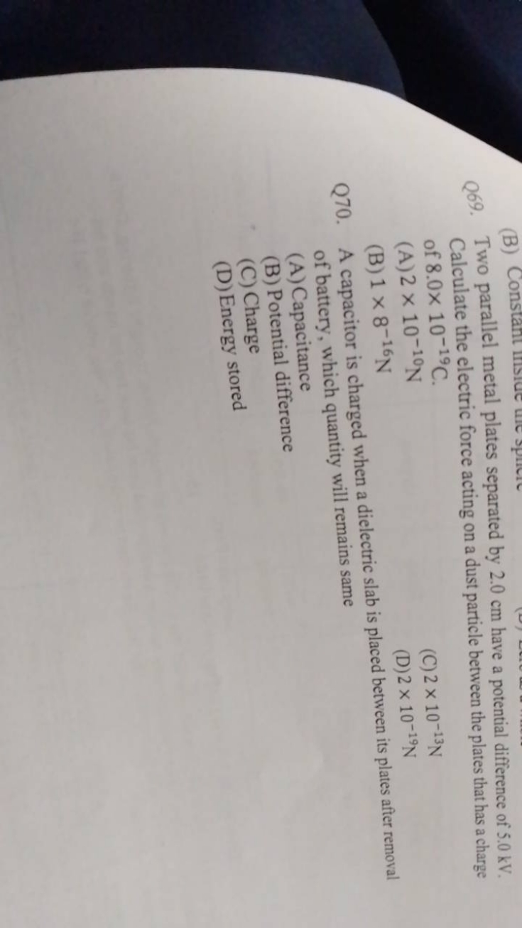 Q69. Two parallel metal plates separated by 2.0 cm have a potential di