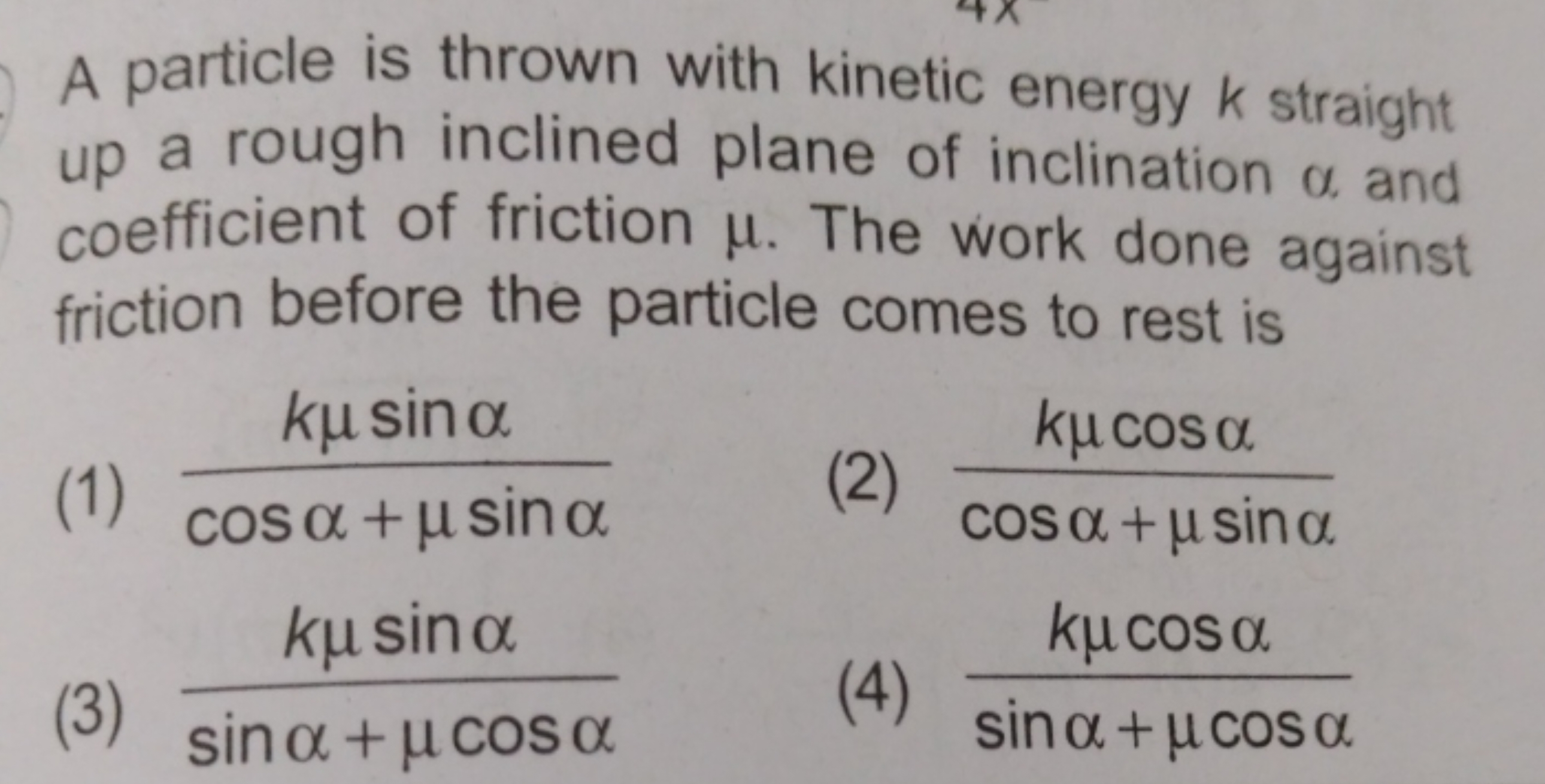 A particle is thrown with kinetic energy k straight up a rough incline