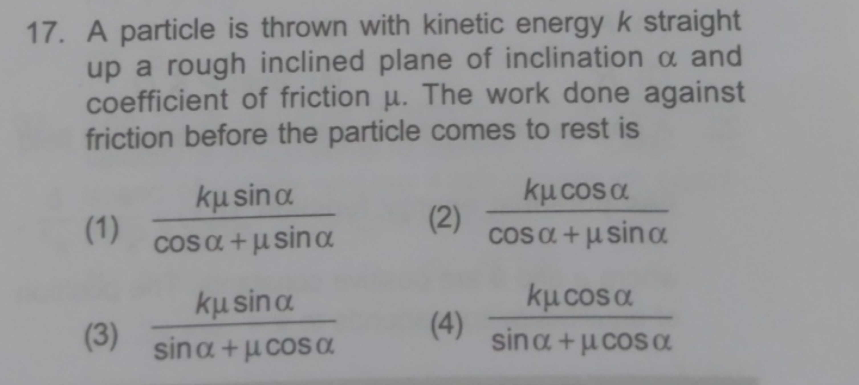 17. A particle is thrown with kinetic energy k straight up a rough inc