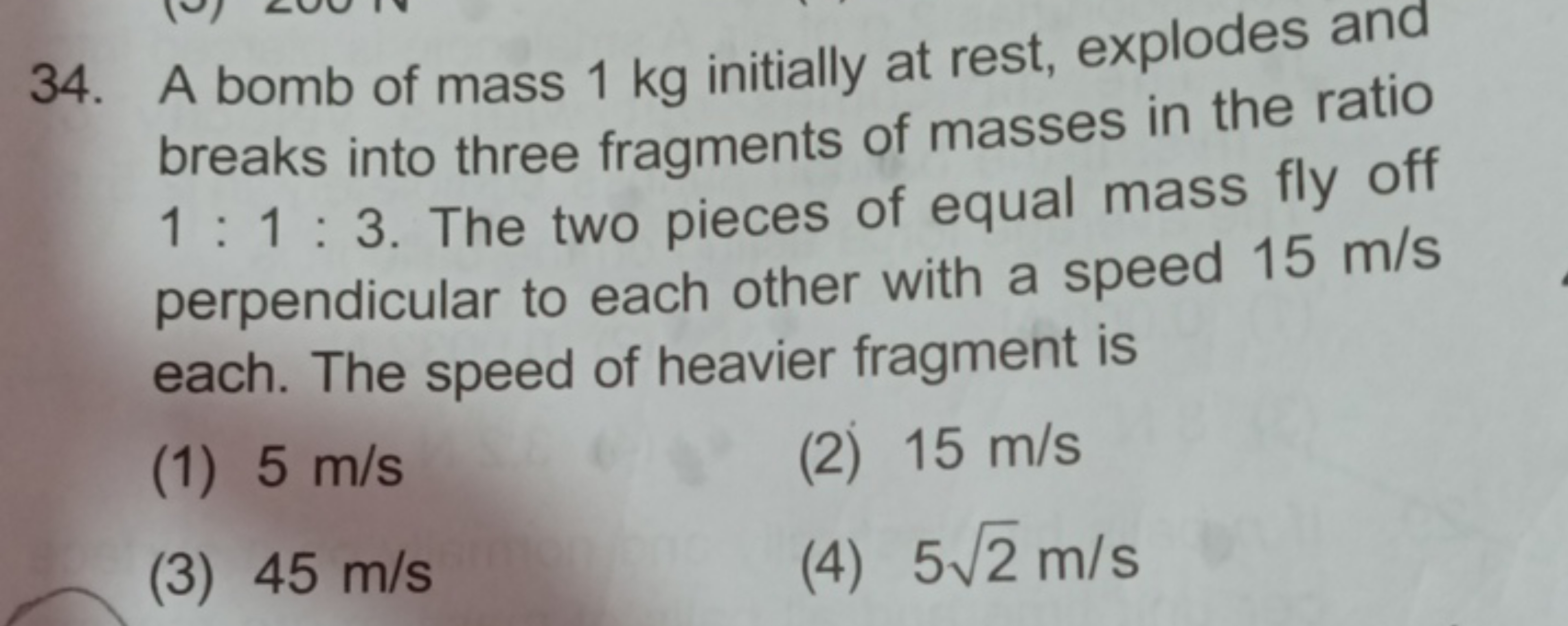 34. A bomb of mass 1 kg initially at rest, explodes and breaks into th