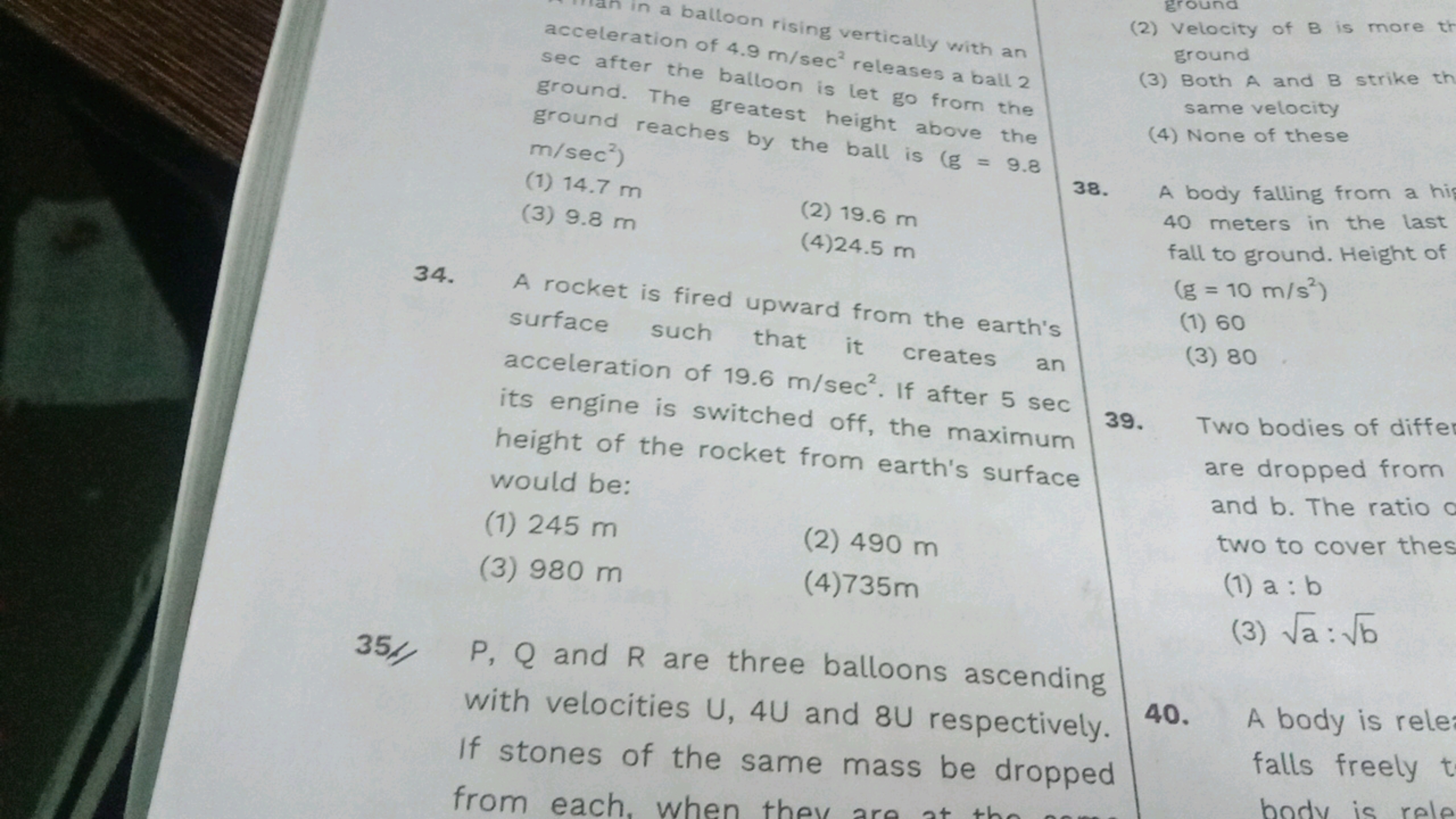 rising vertically with an of 4.9 m/sec2 releases a ball 2 the balloon 