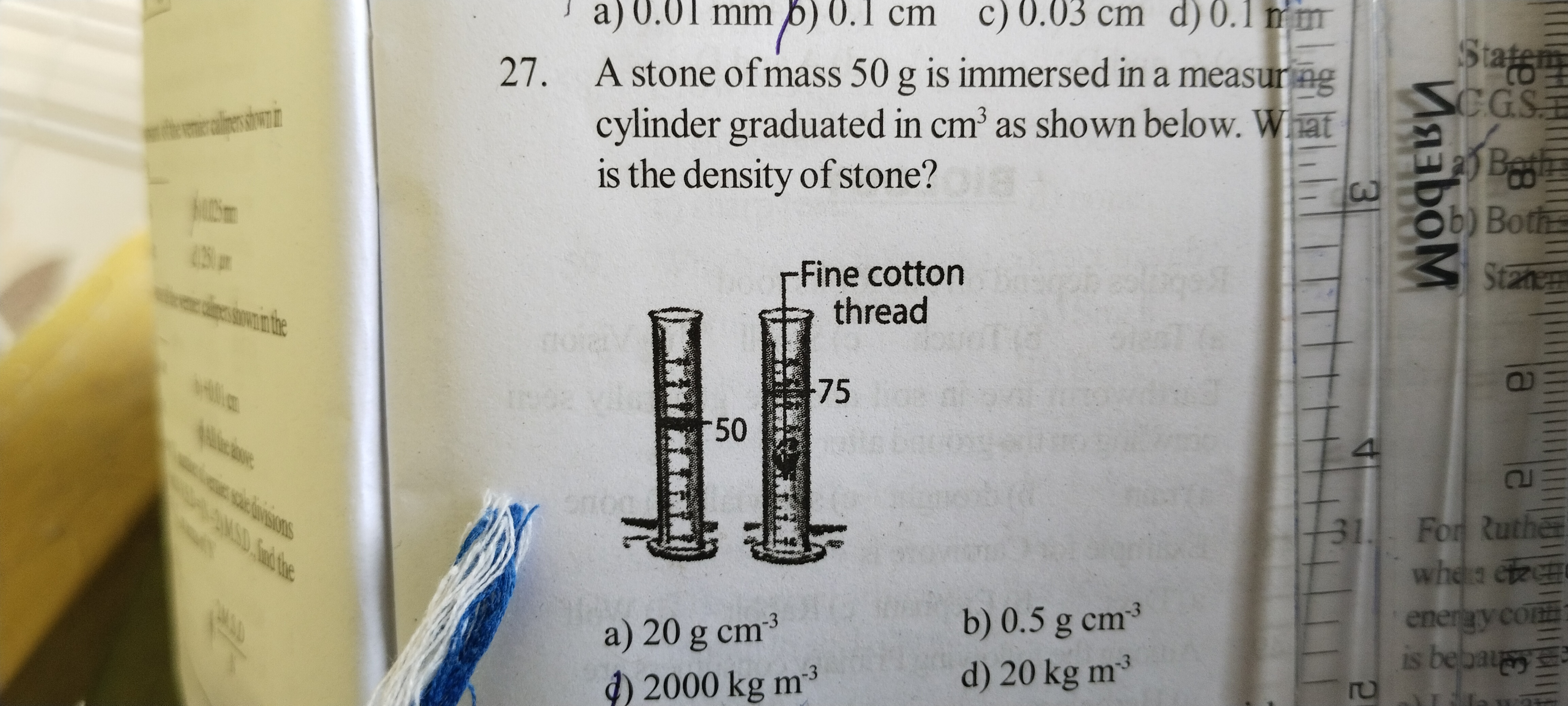 27. A stone of mass 50 g is immersed in a measuring cylinder graduated